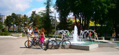 Cyclists in Belgrade city center tazmajdan park at fountain