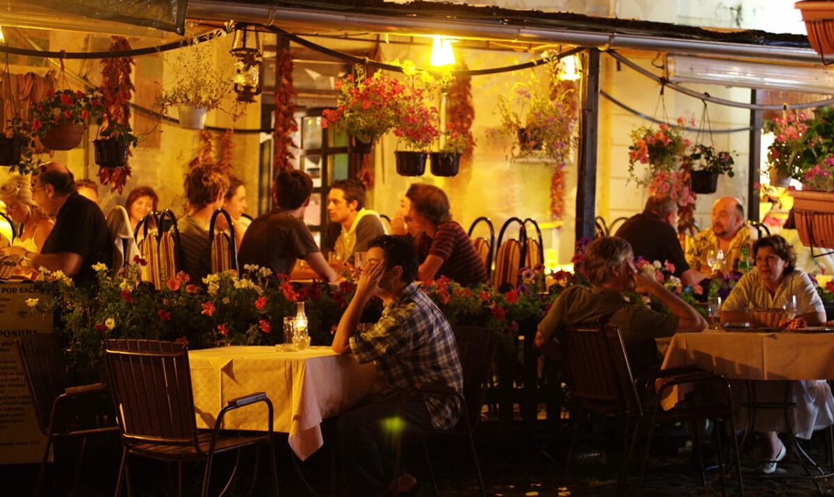 people sitting in kafana at night